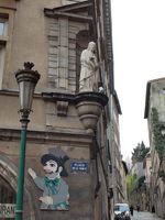 (2026) Photo de la statue de St-Pierre dans une niche à l’angle de la Montée du Gourgillon. Représentation de Gnafron, célèbre compagnon de Guignol.